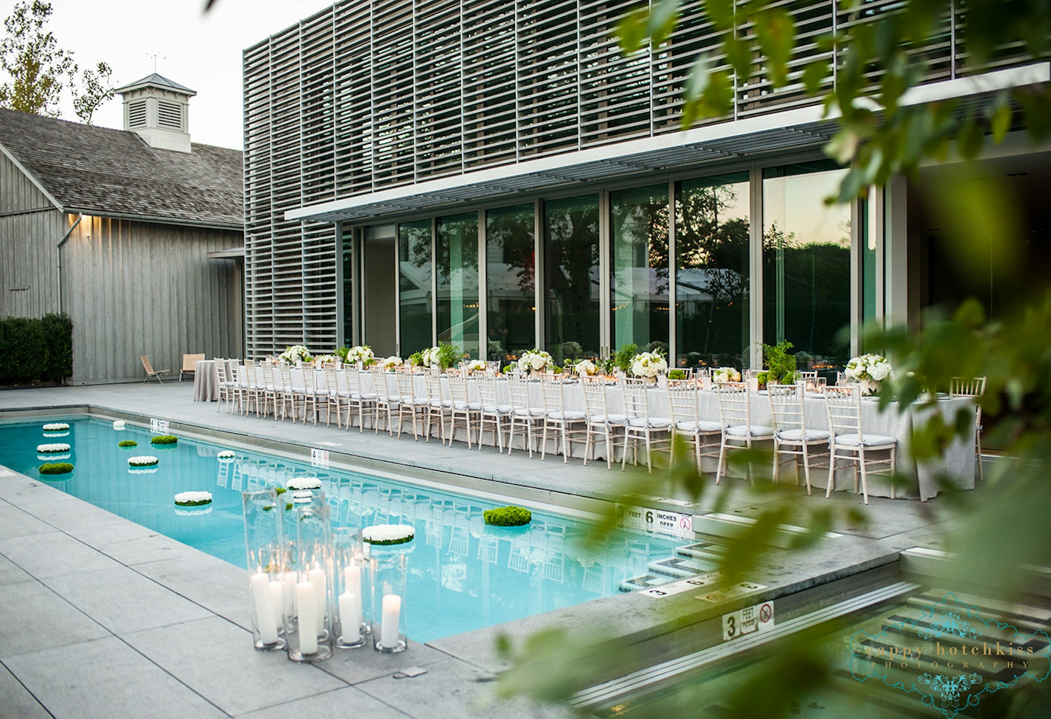poolside wedding reception with greenery and candles in hamptons