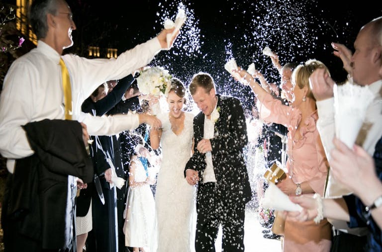 Bride and groom exiting during rice toss