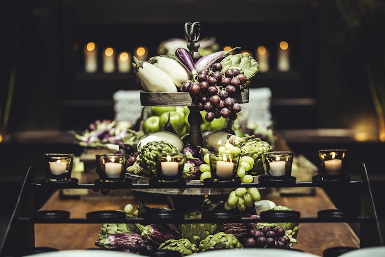 Wedding centerpiece of grapes, apples, and eggplants | PartySlate