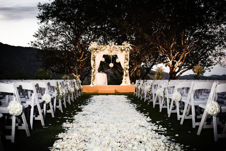 Outdoor ceremonial space with white petal walkway