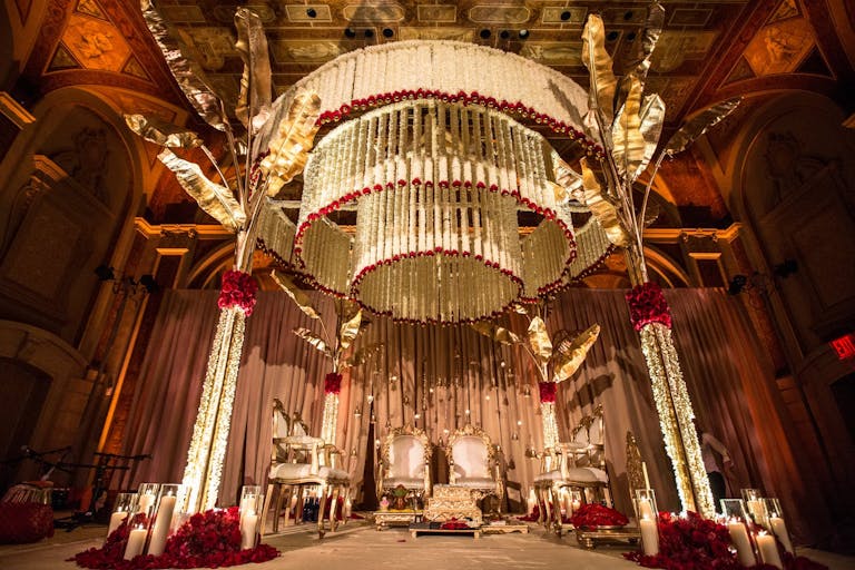 Mandap with concentric circles of suspended white and red blooms | PartySlate