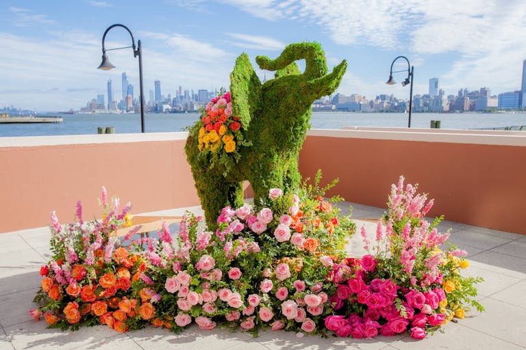 Elephant boxwood wedding sculpture with colorful florals | PartySlate
