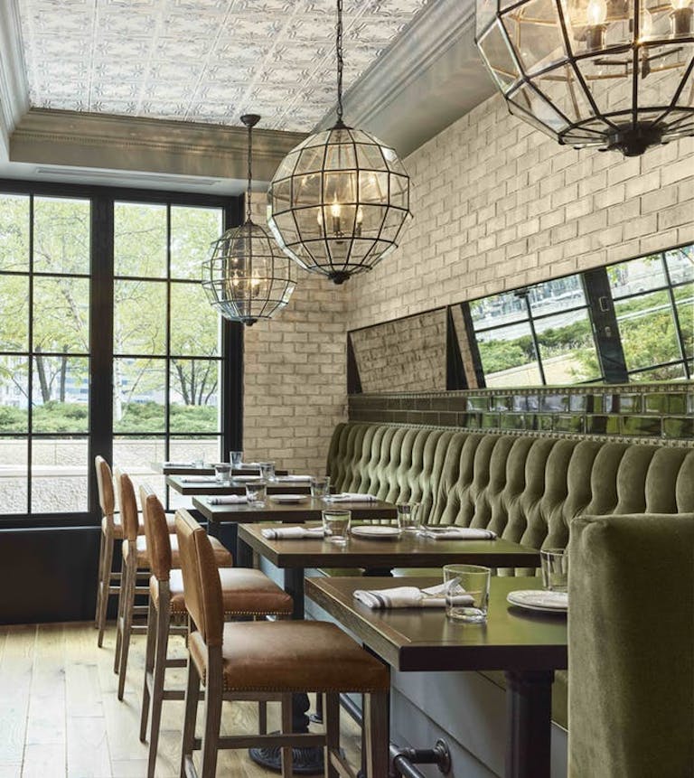 Dining area with exposed brick walls and floor to ceiling windows at Beacon Tavern restaurant | PartySlate