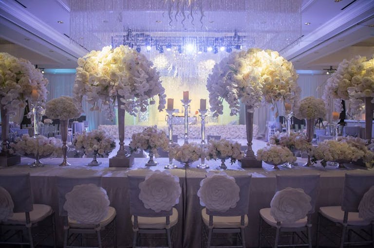Ballroom with all-white décor and blooms | PartySlate