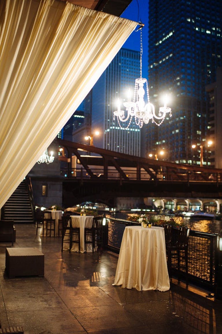 Outdoor area at the River Roast Social House with a chandelier and hardwood floors | PartySlate