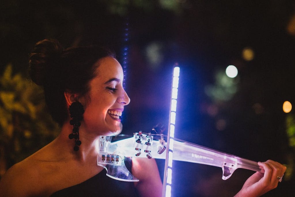 Woman playing a neon-lit violin