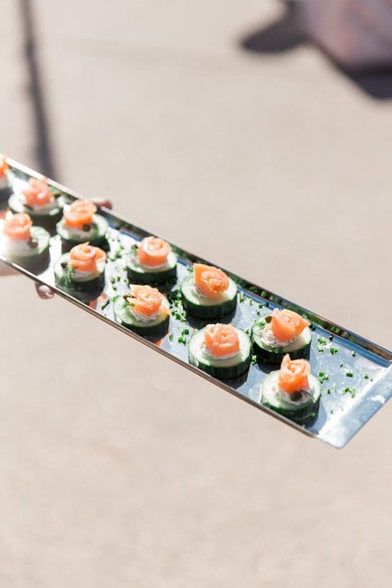 Metal tray with vegetable finger food and salmon | PartySlate