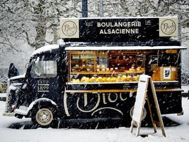 Food truck serving festive pastries in a snowy winter forest | PartySlate