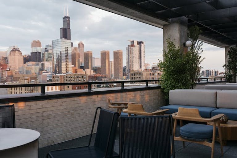 Dining area with Chicago skyline in the background at Ace Hotel Chicago | PartySlate
