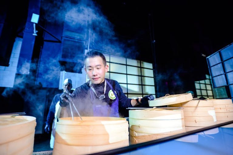 Chef making steaming dumplings | PartySlate