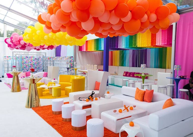 Colorful balloon and rainbow fringe tassels hanging from the ceiling at Bat Mitzvah in NYC | PartySlate