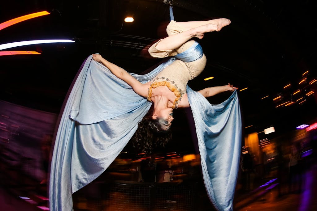 Female aerialist suspended from ceiling | PartySlate