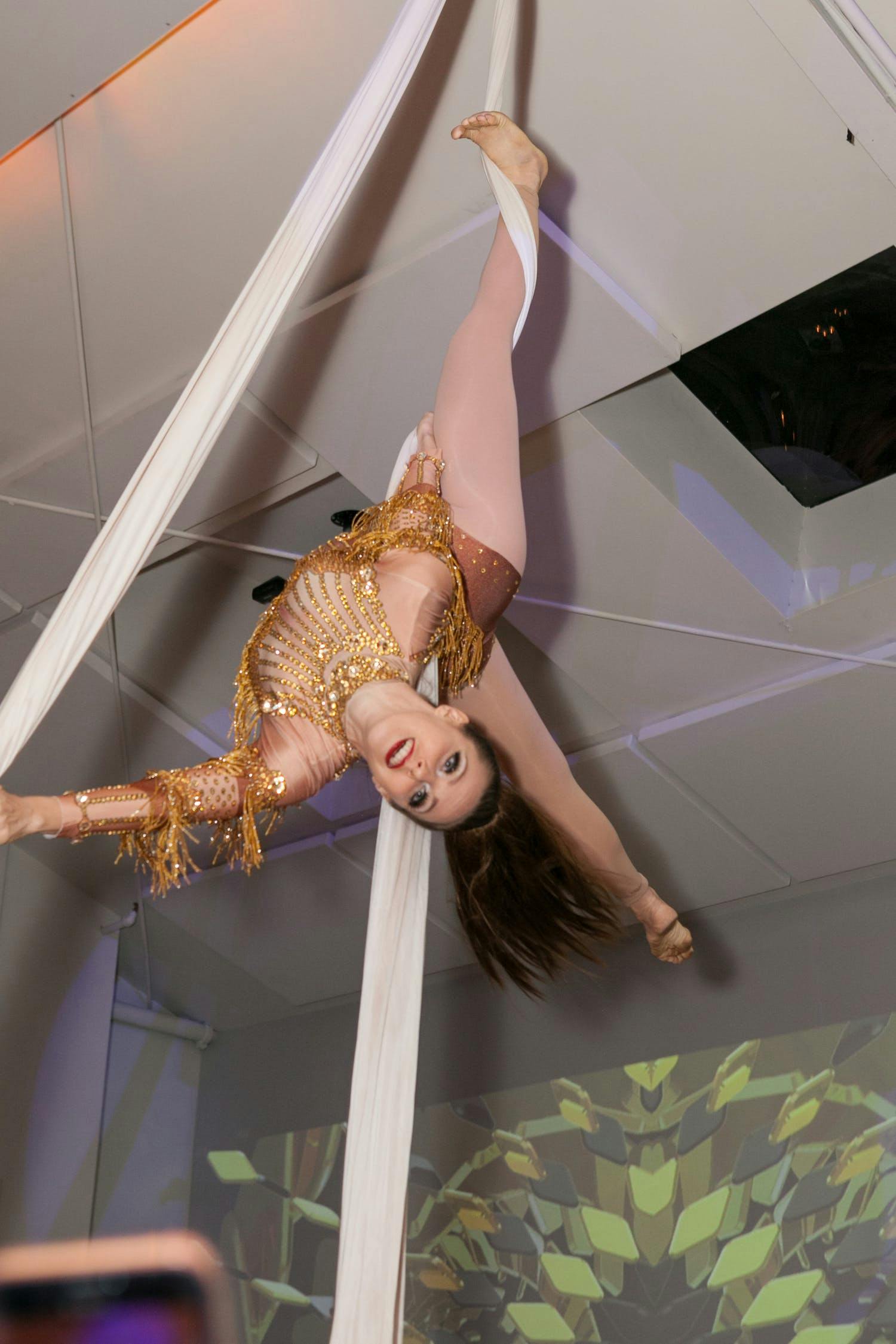 female aerialist suspended from ceiling