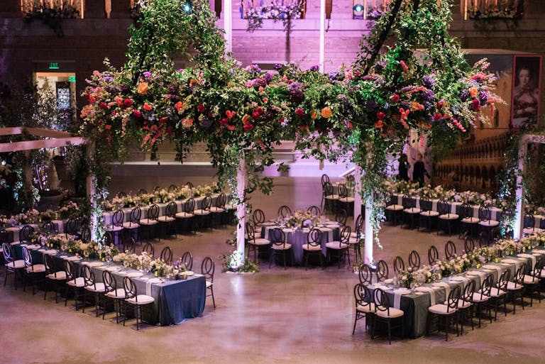 reception area with diamond table formations and lavish foliage
