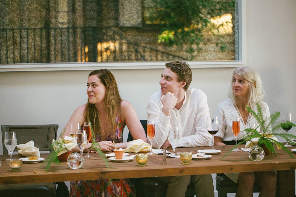 Three guests drinking rosé at a wedding rehearsal dinner | PartySlate