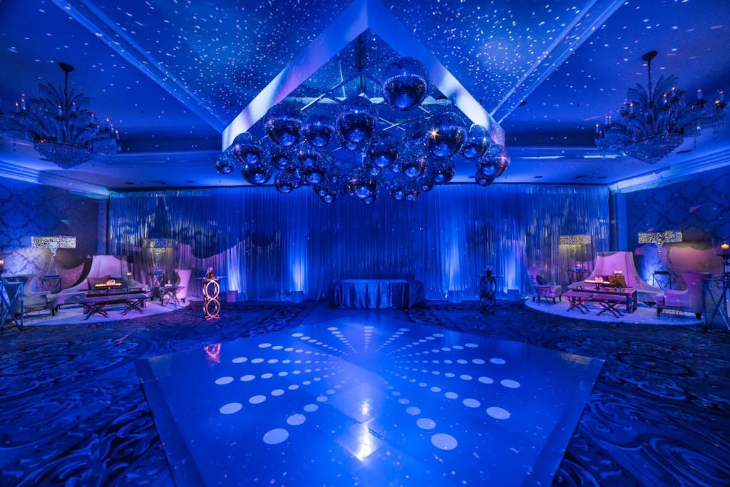 Dance floor with blue uplighting and snowflake projection mapping