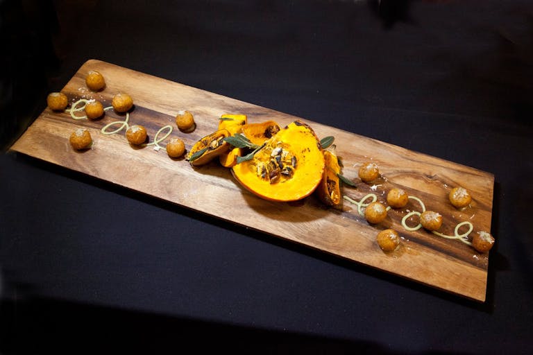 Squash and walnuts on wooden serving tray