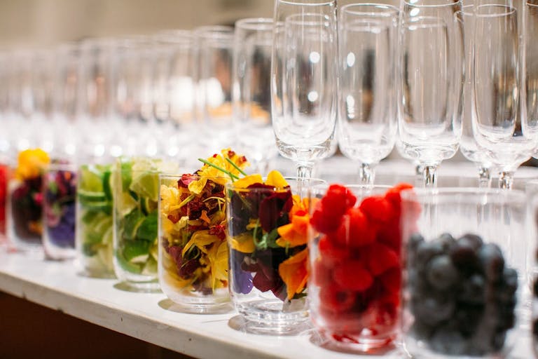wine glasses with an assortment of colorful fruit garnishes