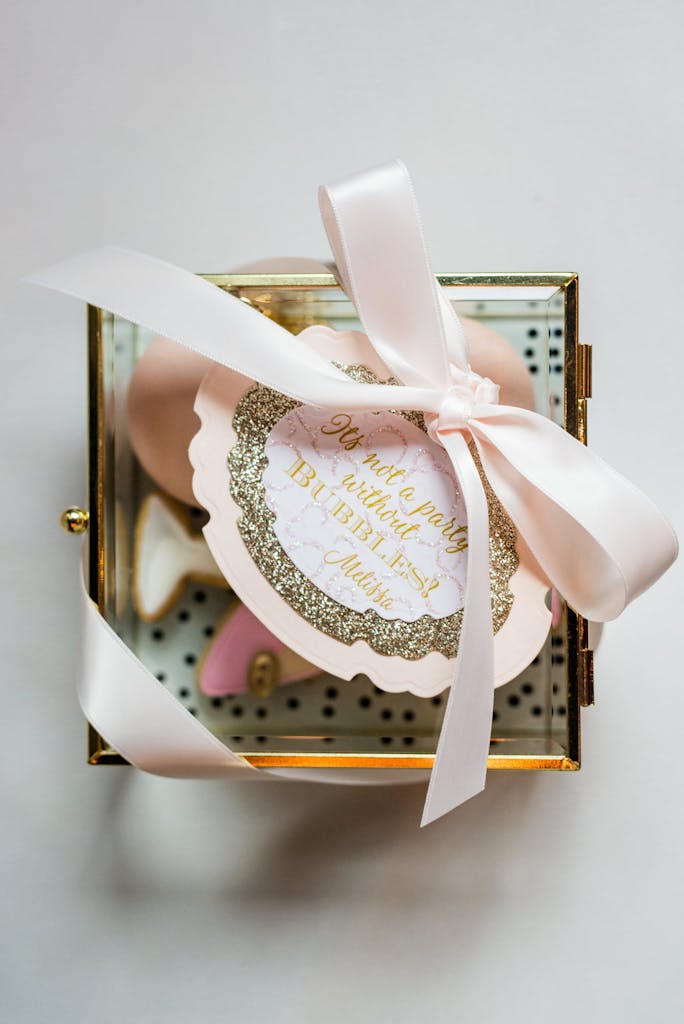Champagne-flavored take-home cookies and pretty packaging for birthday party favor
