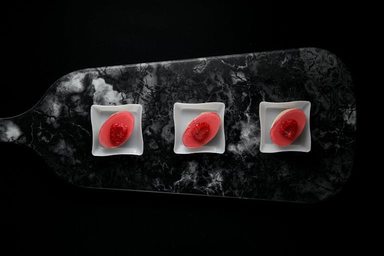 hot-pink small bites served on black, marbled cutting board