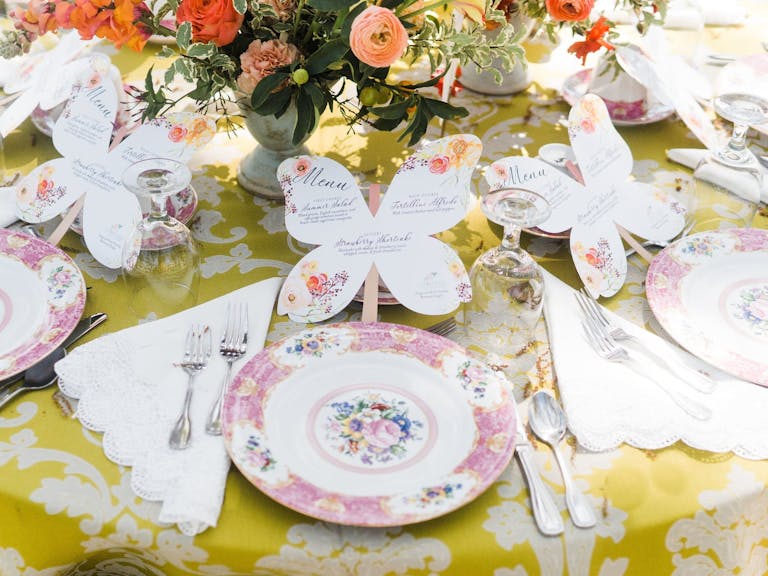 Rose-and-white tablescape with butterfly menus