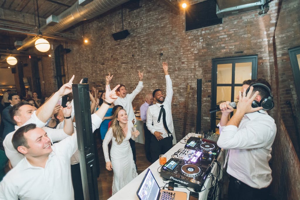 Bride and guests dancing in front of DJ