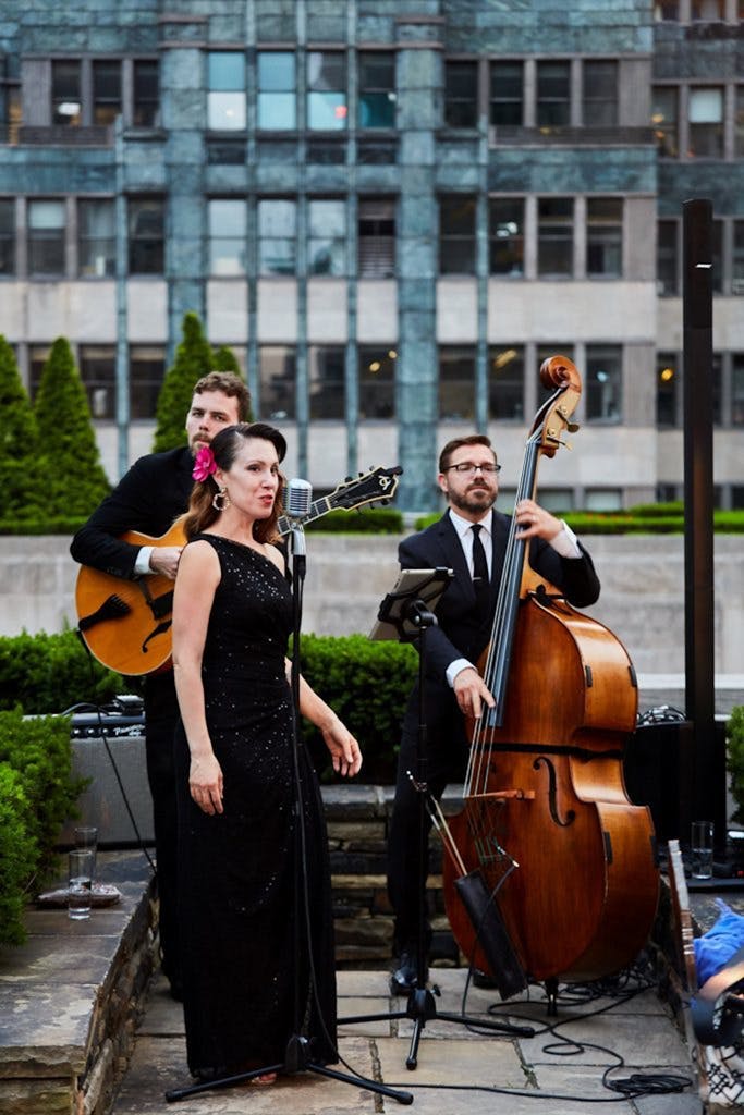 Music trio performing at 620 Loft & Garden for a wedding rehearsal dinner | PartySlate