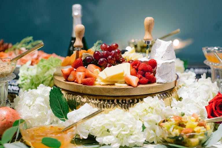 charcuterie spread surrounded by white blooms