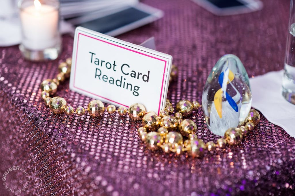Tarot card reading activity station at a wedding rehearsal dinner | PartySlate