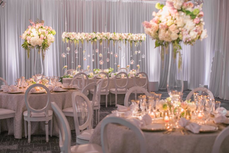 reception area with pink bloom centerpieces and suspended installations