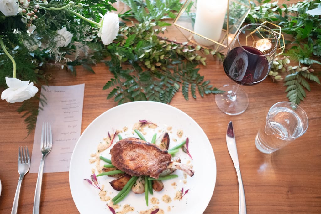 Artfully plated pork chops at a wedding rehearsal dinner | PartySlate