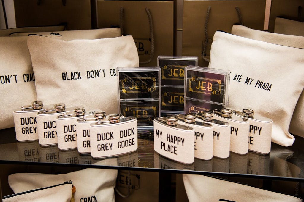 Party favors that include custom-made flasks, accessory bags, and cassette tapes.