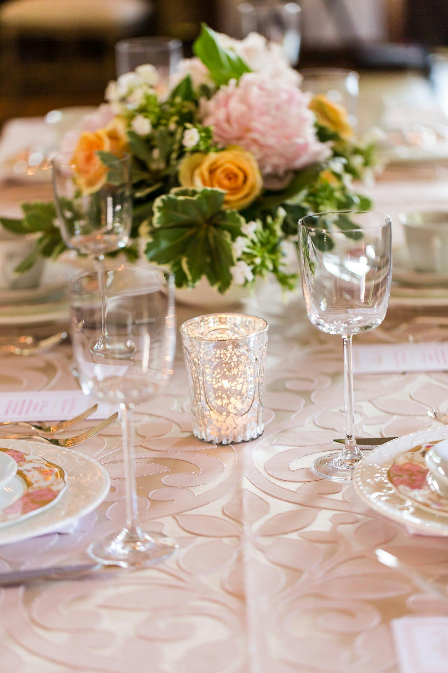 blush colored tablescape with tea light and blooms
