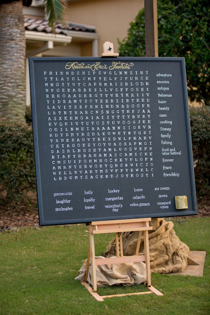 Giant chalkboard word search at an outdoor wedding rehearsal dinner | PartySlate