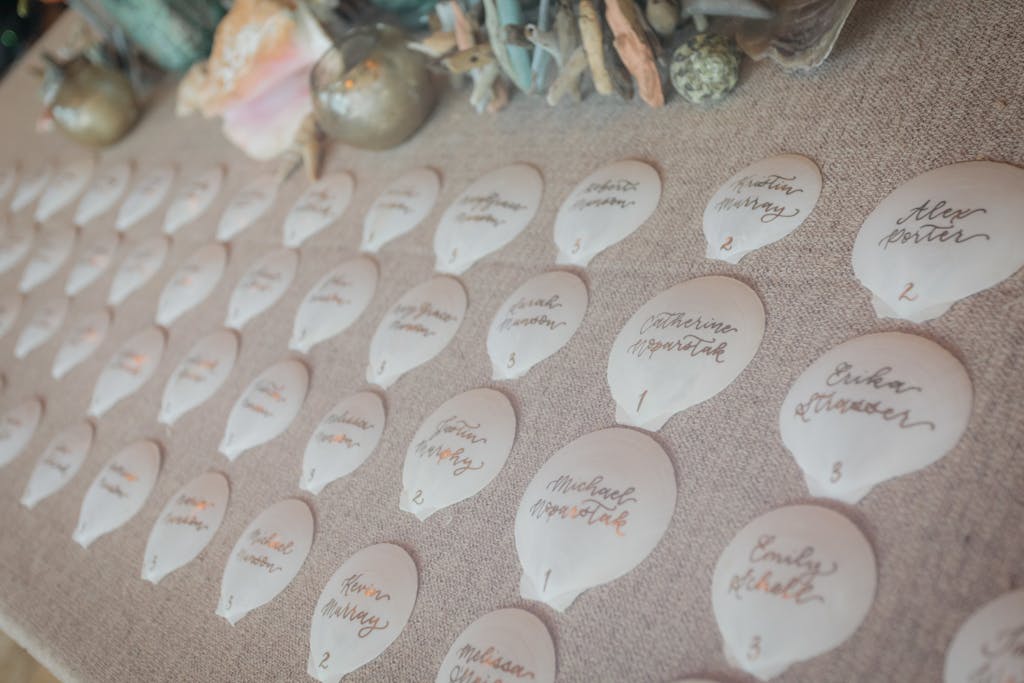 Seating chart of white seashells for a wedding rehearsal dinner | PartySlate