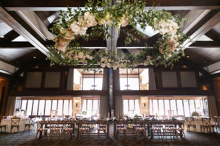 Table in large wood room with circle of flowers on the ceiling.