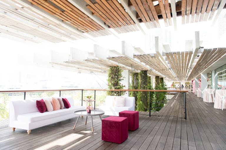 bamboo ceiling with luxe white furniture in an indoor/outdoor area.