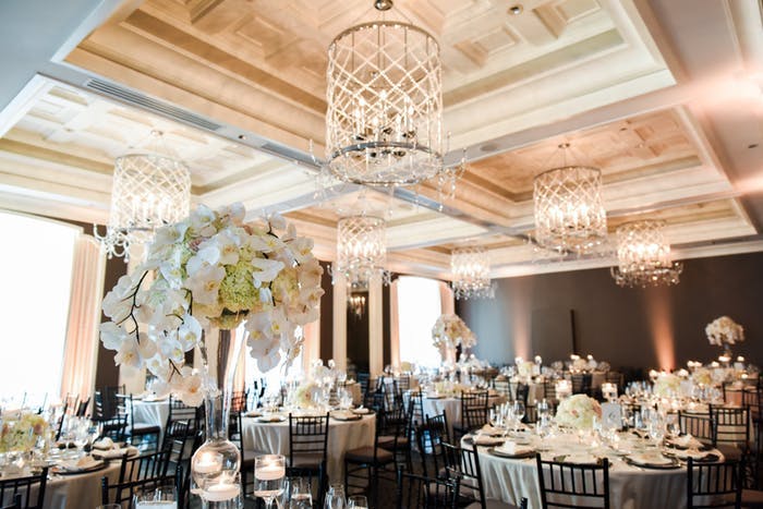 vaulted ceiling in ballroom with tall white orchid wedding centerpieces