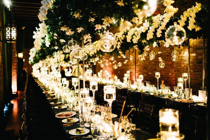 glowing orchid wedding centerpieces down the middle of a long table