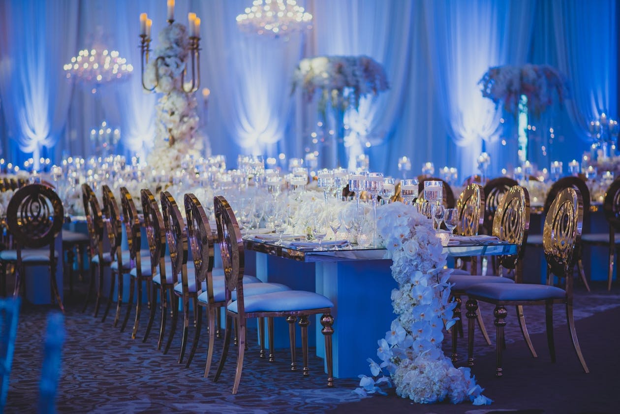 Glamorous and cascading white orchid wedding centerpieces.