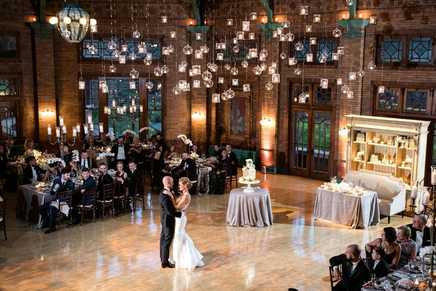 Bride and Groom in the middle of the dance floor with small lights hanging all around.