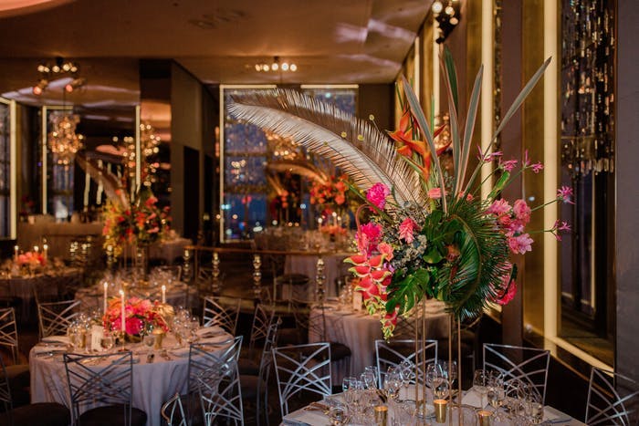 low and high centerpieces with feathers as accent