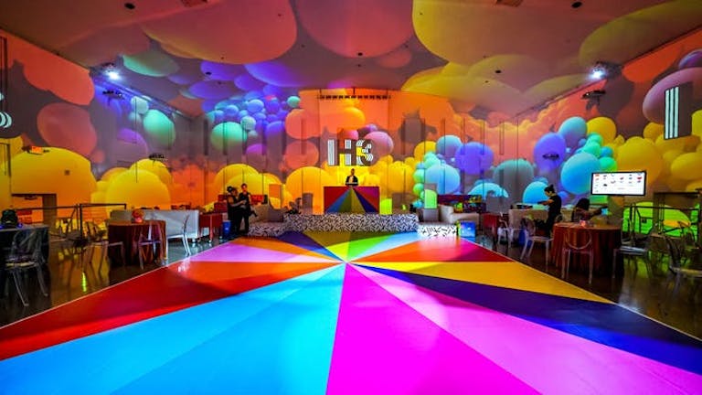 multicolored parachute like flooring with multicolored balloons on ceiling