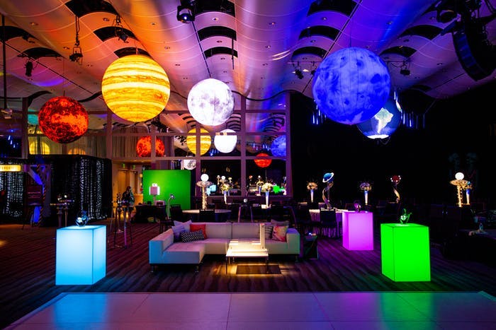 Corporate Event Space-Themed Party With Giant Planetary Décor Ceiling Installation and Rectangular LED Cocktail Tables | PartySlate