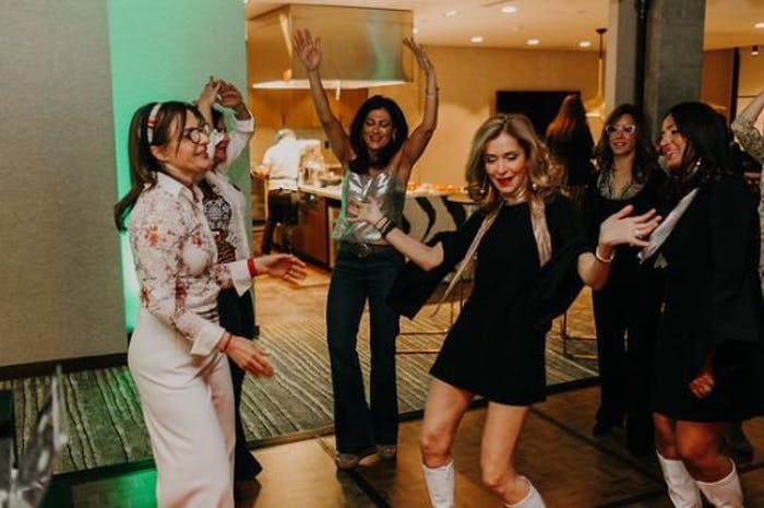 Four Women Dressed in 70s Era Clothing Dance | PartySlate