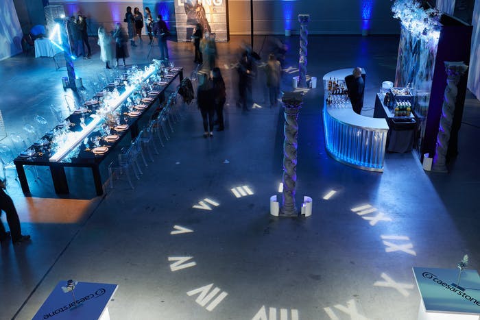 Futuristic Party in Helicopter Hanger With a Clock Lit Up on the Floor | PartySlate