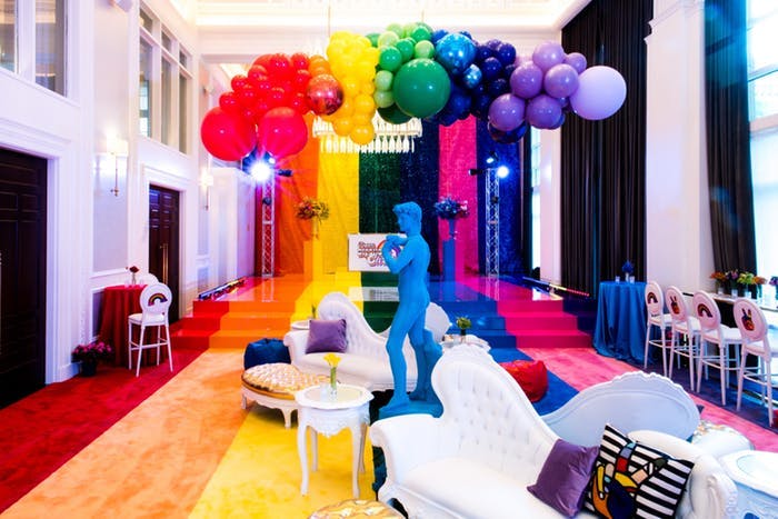 Birthday Party With Rainbow Balloon Installation and Blue Statue | PartySlate