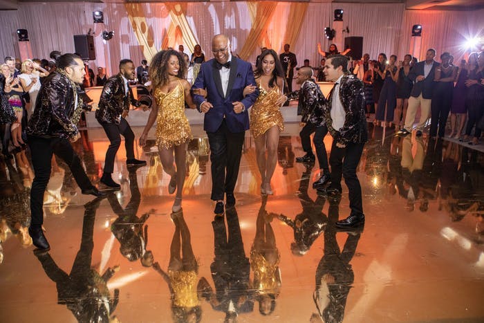 A Couple Walks Through the Dance Floor with Dancers Surrounding Them | PartySlate