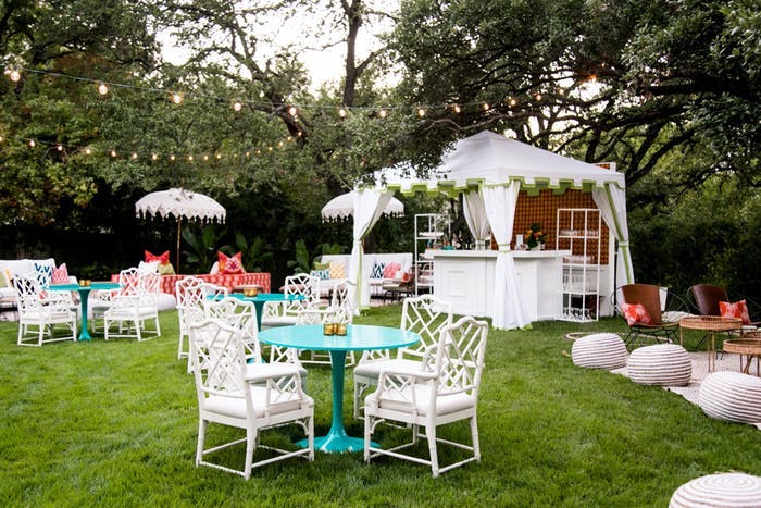 Backyard Outdoor 50th Birthday Party With White Tented Bar and Colorful Cocktail Tables | PartySlate