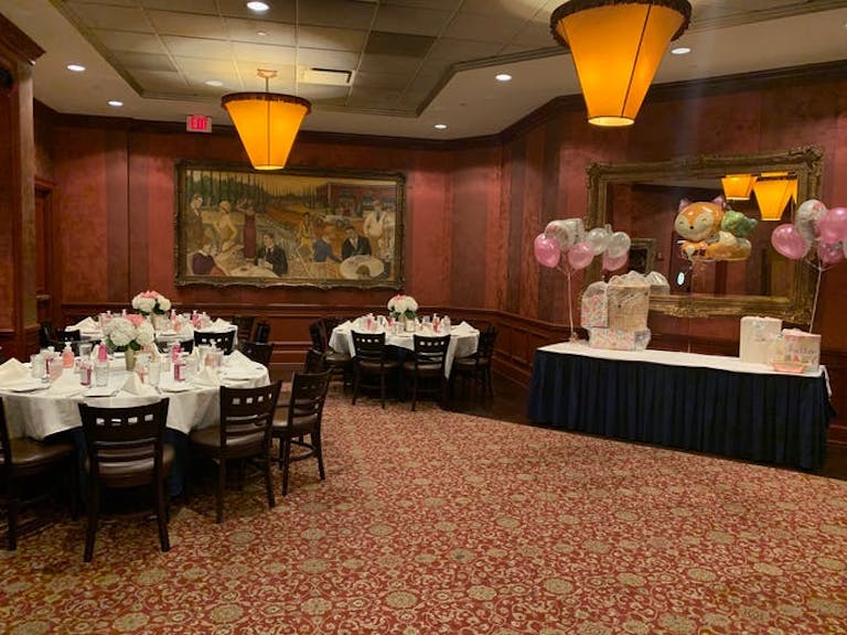 The Clubhouse Oak Brook baby shower venue in Chicago with red walls and red carpet with yellow lighting